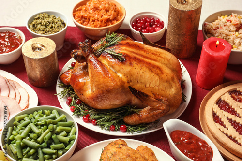 Traditional festive dinner with delicious roasted turkey served on table photo