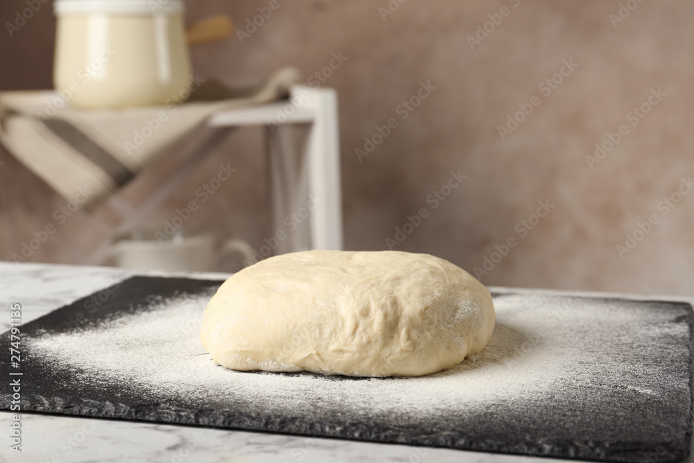 Board with flour and bread dough on table indoors. Space for text Board with flour and bread dough on table indoors. Space for text