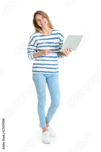 Full length portrait of young woman in casual outfit with laptop on white background