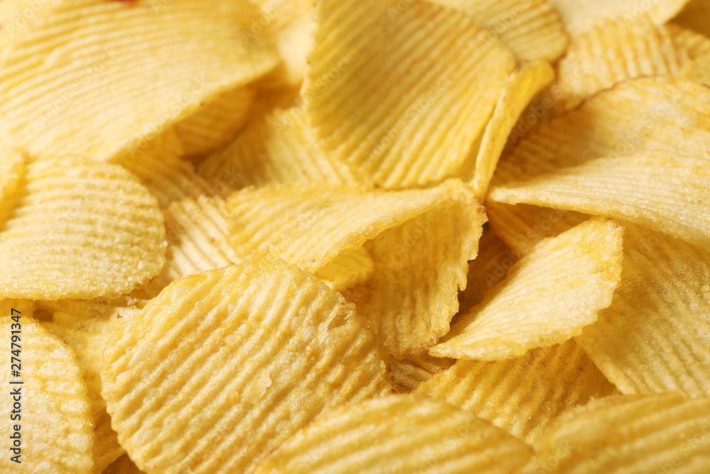 Pile of crispy potato chips as background, closeup Pile of crispy potato chips as background, closeup