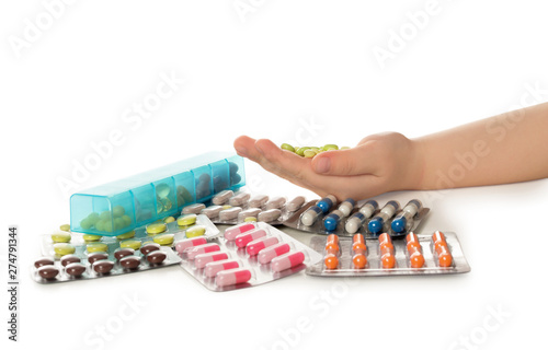 Little child with many different pills on white background  closeup. Danger of medicament intoxication