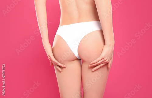 Slim young woman with smooth gentle skin on color background, closeup. Beauty and body care concept