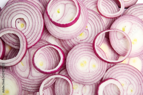 Sliced fresh red onions as background, top view