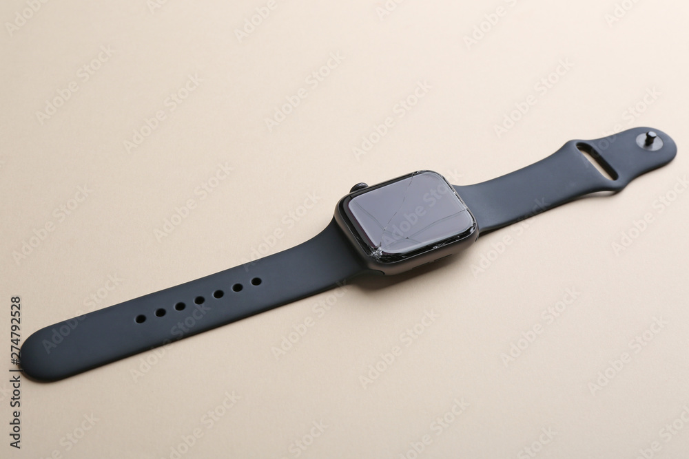 Broken smart watch on color background. Repair service Broken smart watch on color background. Repair service