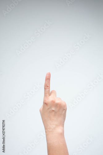 Hand pointing above on white background.