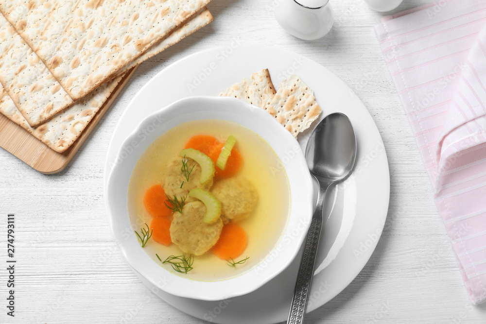 Flat lay composition with Jewish matzoh balls soup on white wooden table Flat lay composition with Jewish matzoh balls soup on white wooden table