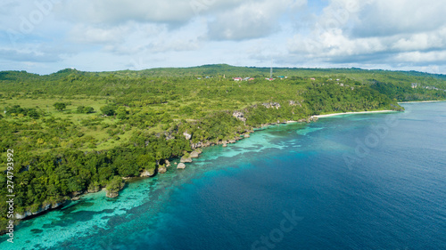 Beautiful aerial view of hill beside blue ocean with nice sky