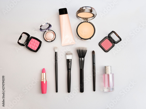 Lipstick, tools, eyeliner, blush, perfume, eye shadow and powder cosmetic in blue theme make up on frame for promotion. Set of decorative cosmetics.