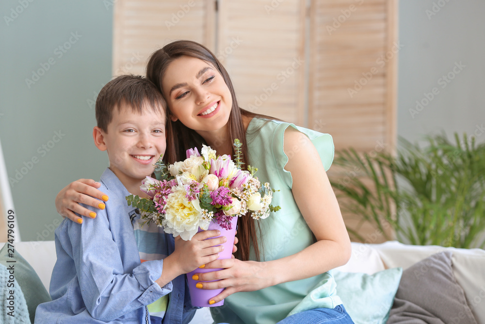 Young mother and son with bouquet of beautiful flowers at home Young mother and son with bouquet of beautiful flowers at home