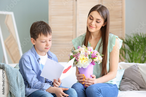 Little son greeting his mot...