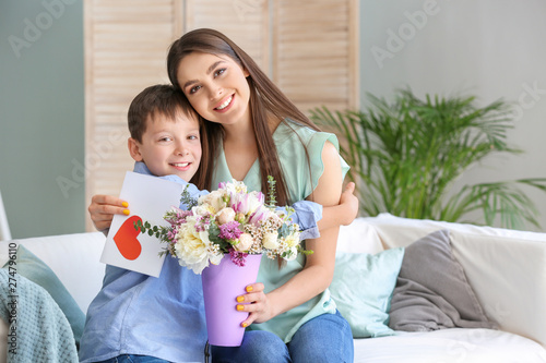 Little son greeting his mot...