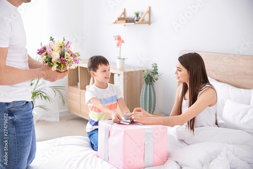 Family greeting young woman...