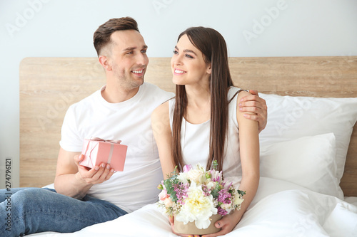 Happy young couple with gif...