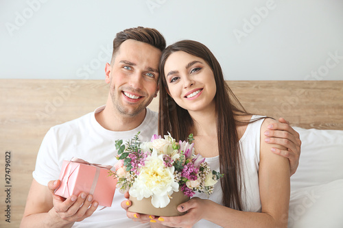 Happy young couple with gif...