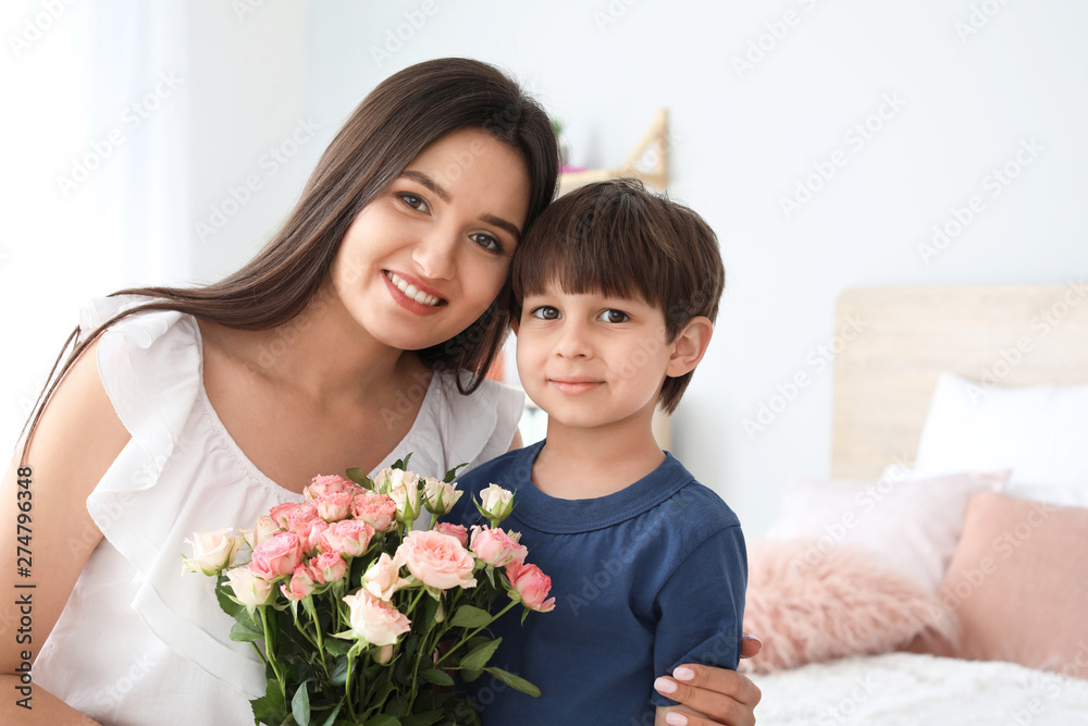 Happy mother and son with bouquet of flowers at home Happy mother and son with bouquet of flowers at home