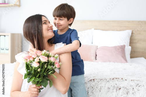 Happy mother and son with b...