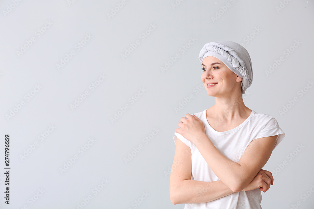 Woman after chemotherapy on light background Woman after chemotherapy on light background