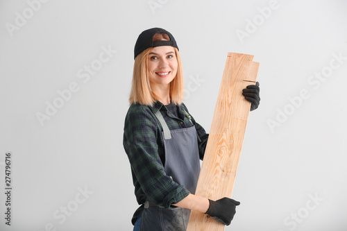 Tableau sur toile Female carpenter on light background