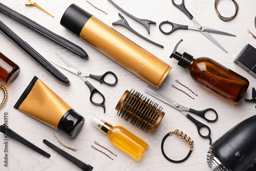 Set of hairdresser tools and accessories on light background