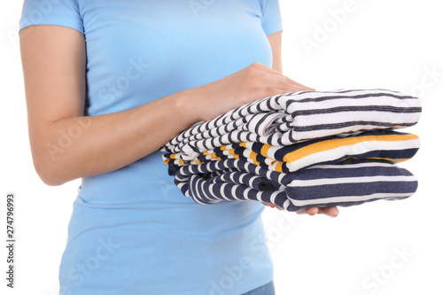 Young woman with stack of clean clothes on white background, closeup © Pixel-Shot