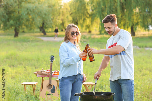 Young couple drinking beer ...