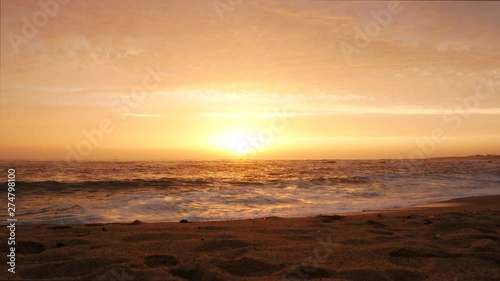 Wide angle shot over sandy beach at sunset in Portugal