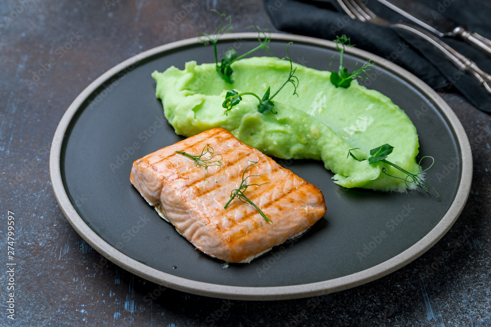 Salmon steak on the grill with green mashed beens Salmon steak on the grill with green mashed beens