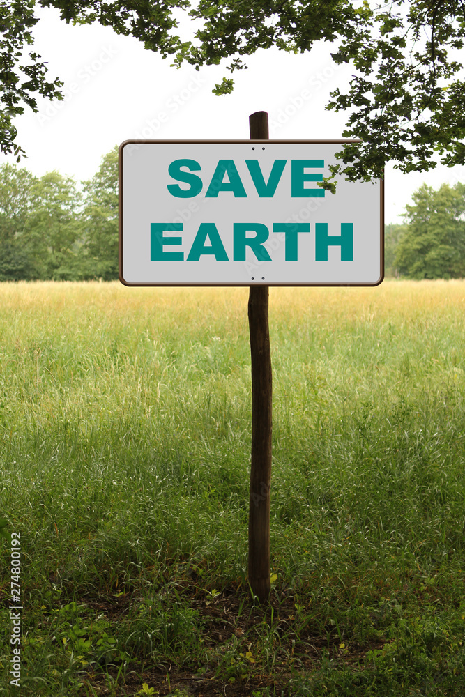 white sign, road sign in the forest on a wooden post with the inscription save the planet earth, concept