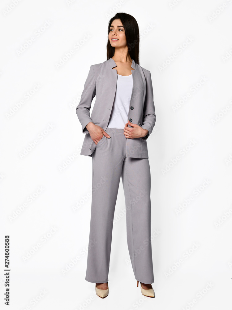 Young beautiful woman manager posing in new casual office suit on a white Young beautiful woman manager posing in new casual office suit on a white