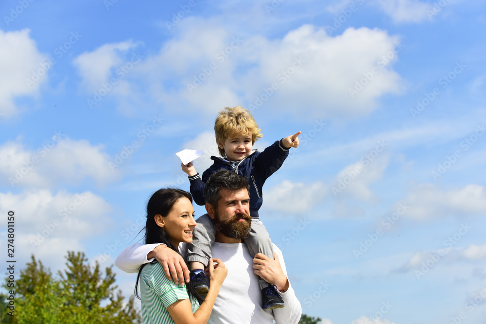 Happy family - mother, father and son on sky background in summer. Freedom to Dream - Joyful Boy Playing With Paper Airplane. Father and his son child boy playing outdoors. Happy family - mother, father and son on sky background in summer. Freedom to Dream - Joyful Boy Playing With Paper Airplane. Father and his son child boy playing outdoors.