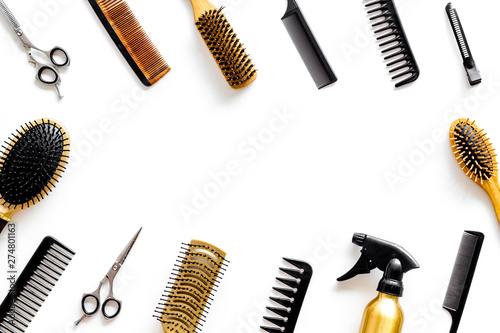 Set of professional hairdresser tools with combs and styling on white background top view frame mock up