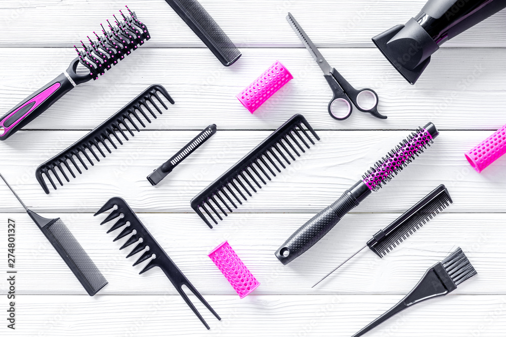 Set of professional hairdresser tools with combs and sciccors on white wooden background top view pattern Set of professional hairdresser tools with combs and sciccors on white wooden background top view pattern