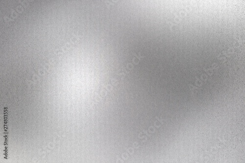 Glowing brushed silver foil metallic sheet, abstract texture background