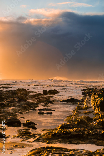 Fototapeta Naklejka Na Ścianę i Meble -  Waves and Rocks at Beach at Sunrise