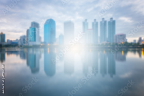 Blur City building with water reflection before sunset