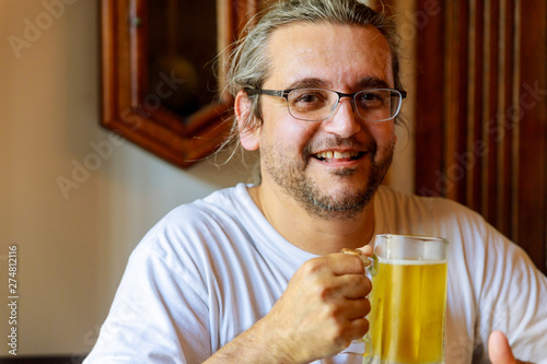 Man drinking beer of handsome man drinking beer while sitting