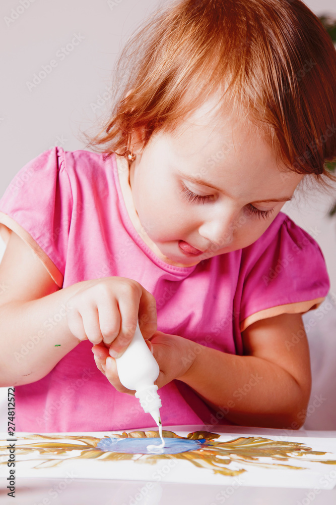 Cute little child girl learning to paint. Child development in art, training, abilities concept. Cute little child girl learning to paint. Child development in art, training, abilities concept.