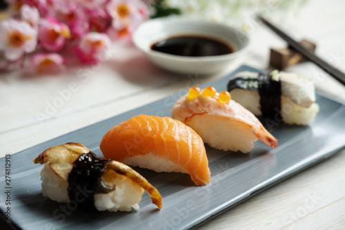 Close up of sashimi sushi set with soy sauce on white wooden table