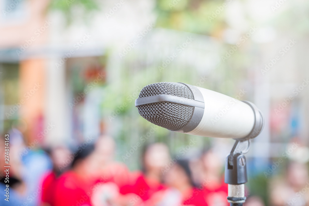 Close up of microphone in public place with blur background Close up of microphone in public place with blur background