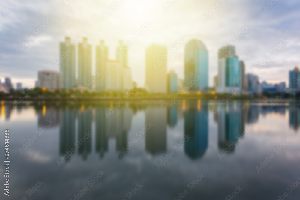 Fototapeta premium Blur City building with water reflection before sunset