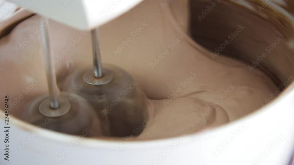 Close up of a food mixer making chocolate cake dough