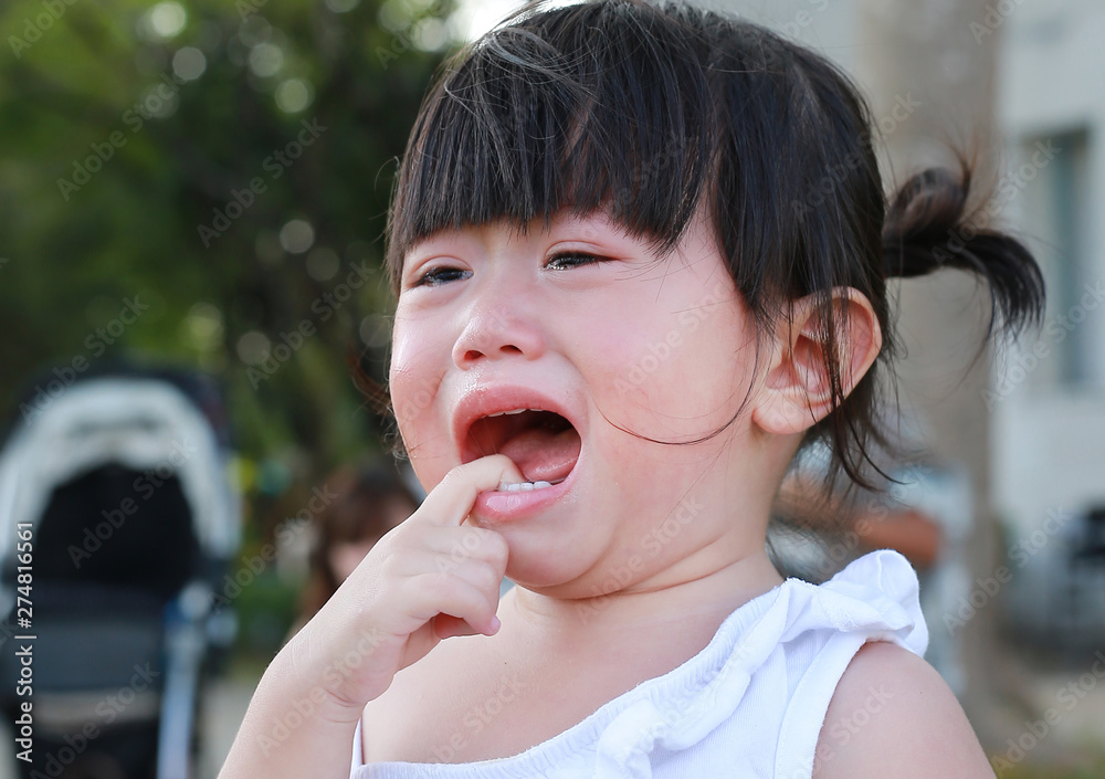 Close-up little girl crying in park Close-up little girl crying in park
