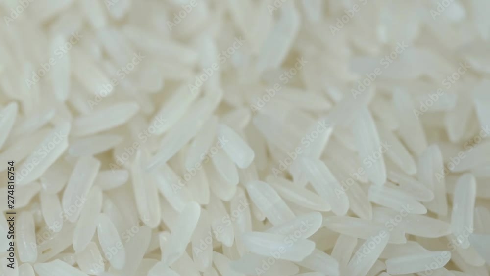 Closeup jasmine white rice, Uncooked products by organic natural food concept, Top view, Slow Motion footage Closeup jasmine white rice, Uncooked products by organic natural food concept, Top view, Slow Motion footage
