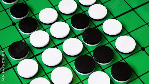 people are playing reversi (othello), board game. this game suitable for adult, kids for practice planning intelligent strategy. it's 4k time lapse footage. photo
