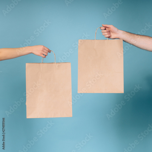 natural paper bag. A man demonstrates and shows a package of natural material. Healthy food