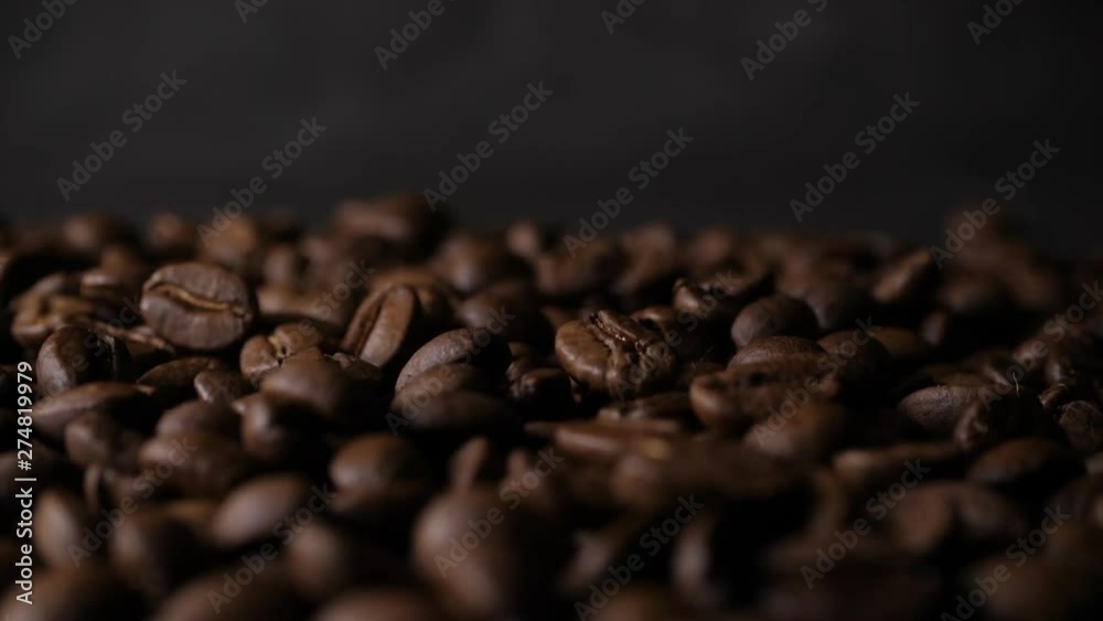 Slow motion 180 FPS Brown roasted coffee beans falling on pile Slow motion 180 FPS Brown roasted coffee beans falling on pile