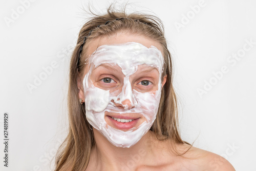 Woman with natural white cream mask on her face