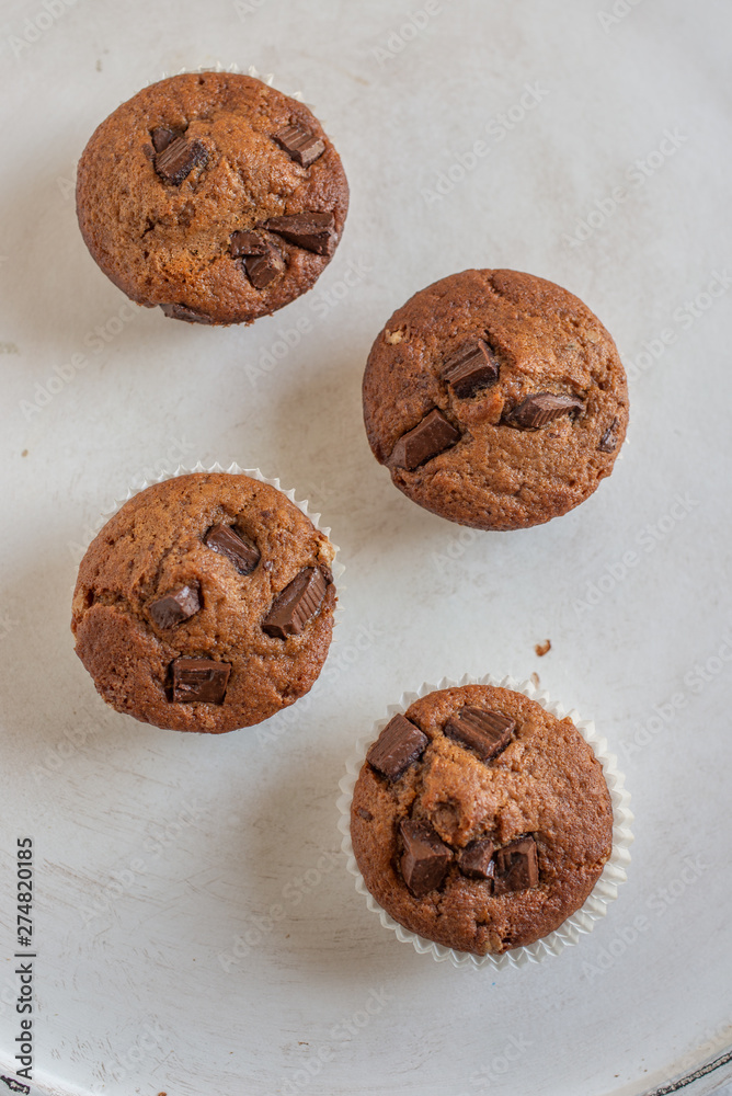 home made chocolate chip muffins in a muffin tray home made chocolate chip muffins in a muffin tray
