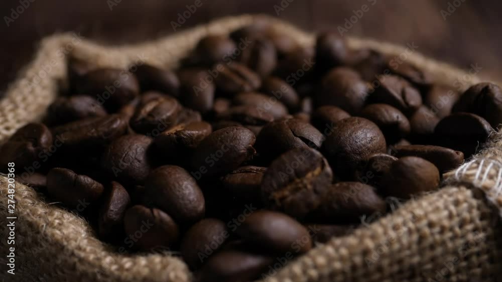 Slow motion 180 FPS Brown roasted coffee beans falling on pile Slow motion 180 FPS Brown roasted coffee beans falling on pile