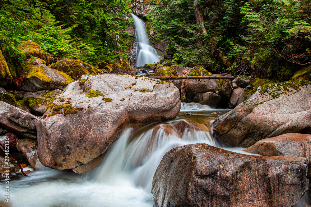 Long exposure waterfall flowing over moss covered rocks